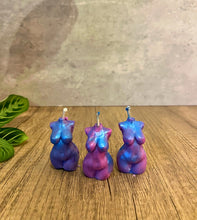 Load image into Gallery viewer, Three colorful unicorn-shaped candles on a wooden surface with a plant in the corner.