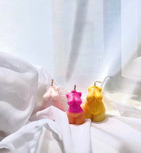 Load image into Gallery viewer, Three colorful body-shaped candles on a white fabric background