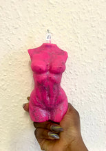 Load image into Gallery viewer, Pink torso-shaped candle held against a textured white background
