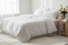 Load image into Gallery viewer, White bed with matching bedding in a bright bedroom setting
